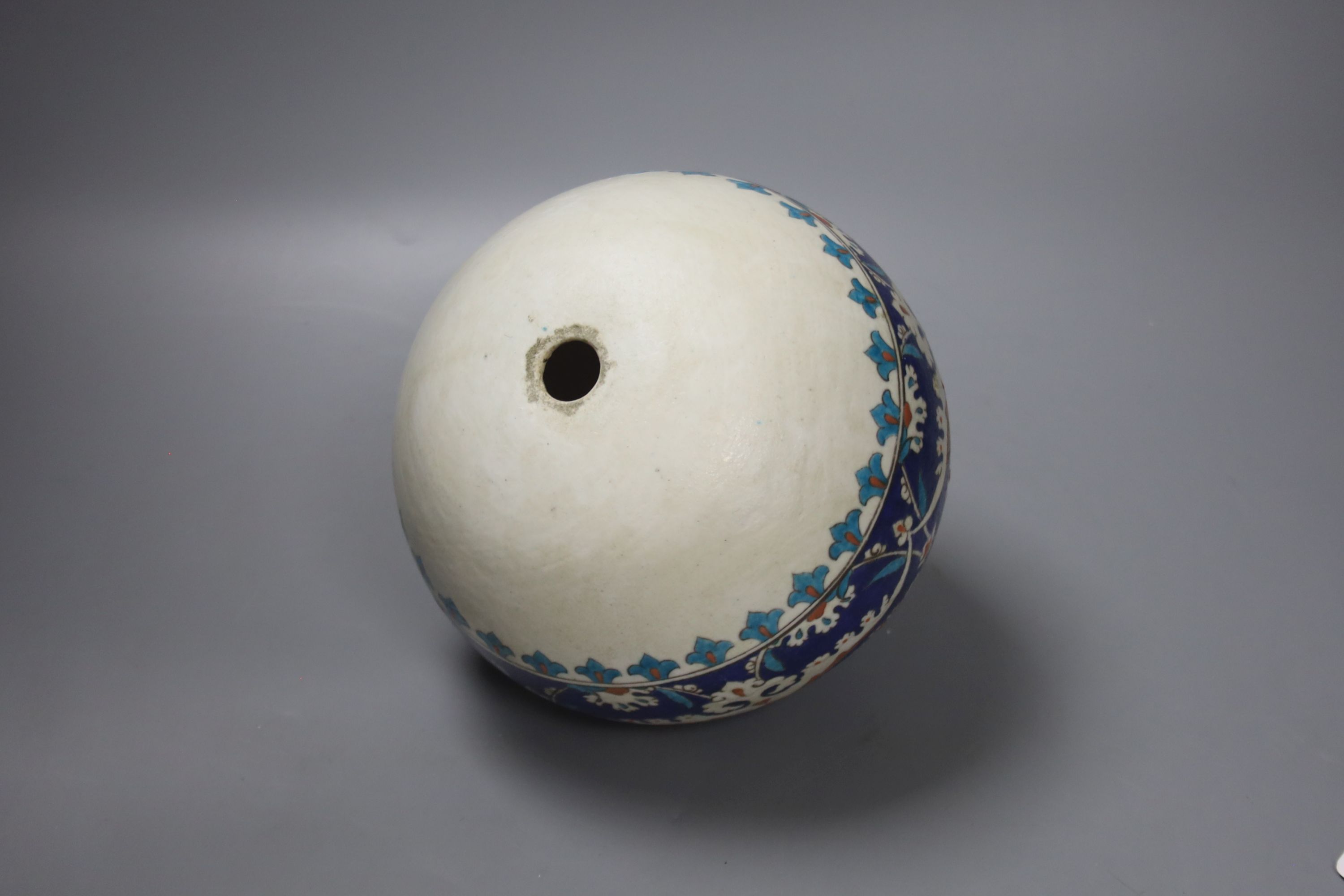 A Turkish Ottoman earthenware hanging mosque bowl, Isnik design, 19cm high